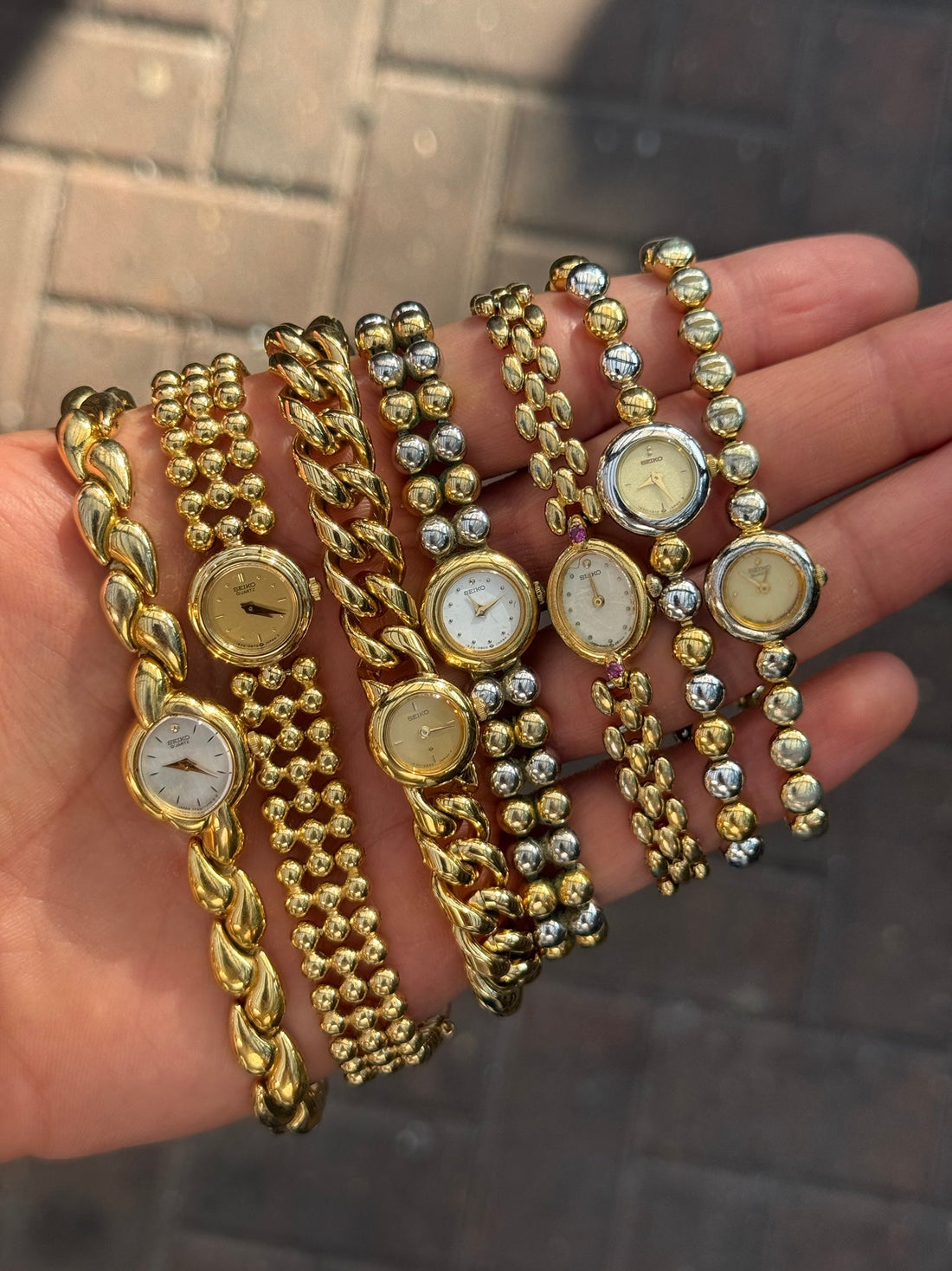 A handful of small vintage Seiko ladies' watches on gold and two-tone bracelets
