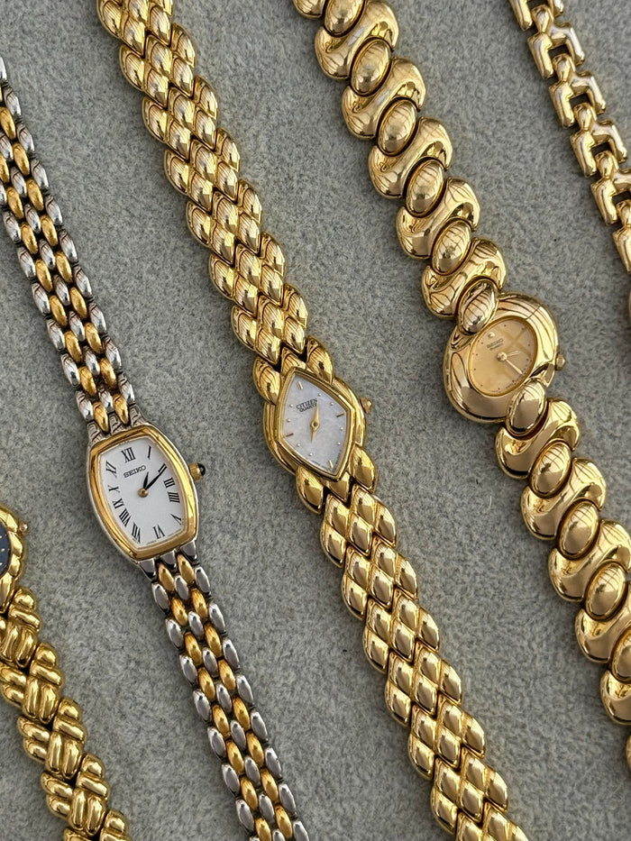 Vintage gold ladies' watches by Seiko and Citizen on gold link bracelets